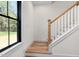 Stairway featuring hardwood steps, white railing, and natural light at 3601 Bivins Rd, Hillsborough, NC 27278