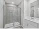 Bathroom features glass shower with gray tile, shower head, and single sink vanity at 3717 Rosebush Dr, Zebulon, NC 27597