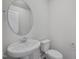Bathroom with pedestal sink, oval mirror, and toilet at 3717 Rosebush Dr, Zebulon, NC 27597