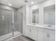 Bathroom features a glass shower and double sink vanity with gray tile accents at 3717 Rosebush Dr, Zebulon, NC 27597
