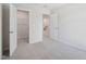 Bedroom featuring an open door leading to a walk-in closet with metal shelves, and an additional doorway at 3717 Rosebush Dr, Zebulon, NC 27597