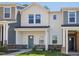 Charming two-story home with a modern farmhouse style, featuring a blue front door and stone accents at 3717 Rosebush Dr, Zebulon, NC 27597