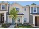 Charming two-story home with a modern farmhouse style and a tree in the front yard at 3717 Rosebush Dr, Zebulon, NC 27597