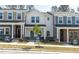 Charming exterior view of townhomes showcases unique architectural details and inviting entryways at 3717 Rosebush Dr, Zebulon, NC 27597
