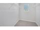 Bright walk-in closet with carpet flooring, metal storage shelves, and a window providing natural light at 3717 Rosebush Dr, Zebulon, NC 27597
