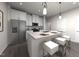 Modern kitchen with stainless steel appliances, white cabinets, a center island with seating, and pendant lights at 3719 Rosebush Dr, Zebulon, NC 27597
