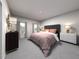 Serene main bedroom with a tufted headboard, soft linens, and ample natural light at 3719 Rosebush Dr, Zebulon, NC 27597