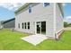Home's backyard includes a small patio, sliding glass doors, and green grass at 3825 Rosebush Dr, Zebulon, NC 27597