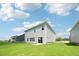 Spacious backyard with a well-maintained lawn and contemporary home with sliding glass doors to the outdoors at 3825 Rosebush Dr, Zebulon, NC 27597