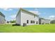 Well-manicured backyard featuring a lush green lawn and neutral siding of a modern, two-story home at 3825 Rosebush Dr, Zebulon, NC 27597