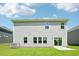 Backyard view shows the siding, the grass, a small patio, and the AC unit at 3825 Rosebush Dr, Zebulon, NC 27597