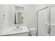 Clean bathroom featuring a quartz vanity, large mirror and glass enclosed shower at 3825 Rosebush Dr, Zebulon, NC 27597