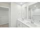 Bright bathroom features a double sink vanity, large mirrors, and an adjacent closet at 3825 Rosebush Dr, Zebulon, NC 27597