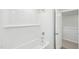 Clean bathroom features a tub with white subway tiles, a shower head, and an open door to a closet at 3825 Rosebush Dr, Zebulon, NC 27597