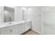 A bathroom featuring double sinks with modern fixtures and a view to the adjacent room at 3825 Rosebush Dr, Zebulon, NC 27597