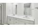 A bathroom featuring double sinks with modern fixtures and large mirrors at 3825 Rosebush Dr, Zebulon, NC 27597