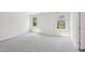 An empty bedroom with neutral carpet and two windows allowing for natural light at 3825 Rosebush Dr, Zebulon, NC 27597