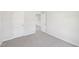 Bright bedroom featuring neutral carpet, white walls, and an open doorway to the hall at 3825 Rosebush Dr, Zebulon, NC 27597