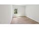 Cozy bedroom with wood-look floors, a bright window, and plenty of space at 3825 Rosebush Dr, Zebulon, NC 27597