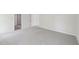An empty bedroom featuring neutral carpet and a doorway into another room at 3825 Rosebush Dr, Zebulon, NC 27597