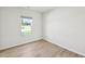 Bright bedroom with large window, light-colored walls, and wood-look flooring at 3825 Rosebush Dr, Zebulon, NC 27597