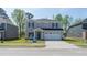 Charming two-story home with a two car garage and a well-manicured front yard at 3825 Rosebush Dr, Zebulon, NC 27597