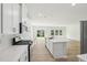 Well-lit kitchen features a center island, stainless appliances, and an open layout to the living room at 3825 Rosebush Dr, Zebulon, NC 27597