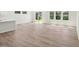 Open-concept living room with wood-look floors, recessed lighting, and natural light from windows at 3825 Rosebush Dr, Zebulon, NC 27597