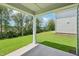 Open back porch with green backyard and clear blue skies above at 3829 Rosebush Dr, Zebulon, NC 27597