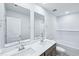 Bathroom showcasing double vanity sinks, modern fixtures, and a tiled tub at 3829 Rosebush Dr, Zebulon, NC 27597
