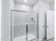 Modern bathroom featuring a glass enclosed shower with white tiling and modern fixtures at 3829 Rosebush Dr, Zebulon, NC 27597