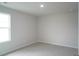 Bedroom with carpet floors and a single window showcasing natural light at 3829 Rosebush Dr, Zebulon, NC 27597