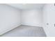Neutral bedroom with plush carpet, light walls, electrical outlets, and a white door at 3829 Rosebush Dr, Zebulon, NC 27597