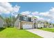 Inviting two-story home with a green lawn, complemented by a two-car garage and well-maintained surroundings at 3829 Rosebush Dr, Zebulon, NC 27597