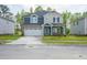 Beautiful two-story home featuring a two-car garage and covered front porch, surrounded by a lush green lawn at 3829 Rosebush Dr, Zebulon, NC 27597