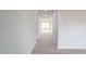 Bright hallway with wood-look floors leading to a window-lit living space at 3829 Rosebush Dr, Zebulon, NC 27597