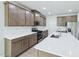 Well-equipped kitchen with quartz countertops, stainless steel appliances, and ample cabinet space at 3829 Rosebush Dr, Zebulon, NC 27597