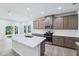 Modern kitchen with a large island, stainless steel appliances, and plenty of cabinet space for storage at 3829 Rosebush Dr, Zebulon, NC 27597