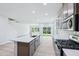 Bright open kitchen with stainless steel appliances, large island, and modern finishes at 3829 Rosebush Dr, Zebulon, NC 27597