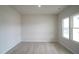 Empty living room featuring natural light, light walls, and wood-look flooring at 3829 Rosebush Dr, Zebulon, NC 27597