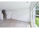 Large room with stairs, big window and neutral wall color at 3829 Rosebush Dr, Zebulon, NC 27597