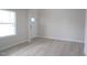 Living area featuring natural light with light walls and light wood-look flooring at 3829 Rosebush Dr, Zebulon, NC 27597