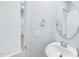 Stylish powder room with pedestal sink, round mirror and modern fixtures at 3829 Rosebush Dr, Zebulon, NC 27597