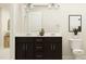 This bathroom features a dual sink vanity, white countertop, and a neutral color palette at 4020 Shadbush St, Raleigh, NC 27616