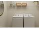 Convenient laundry room with a modern washer, dryer, wire shelving, and plenty of storage space at 4020 Shadbush St, Raleigh, NC 27616