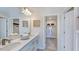This bathroom features double sinks, white cabinets, granite countertops, and a view into a walk-in closet at 408 Carpels Dr, Wendell, NC 27591