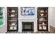 Modern fireplace featuring custom shelving and a flat screen television at 4101 Shadbush St, Raleigh, NC 27616