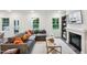 Cozy living room featuring a fireplace, a comfortable couch, large windows, and hardwood-style floors at 4101 Shadbush St, Raleigh, NC 27616