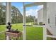 View from a screened porch overlooking the lush backyard and the exterior of the home at 4101 Shadbush St, Raleigh, NC 27616