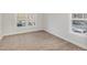 A carpeted room with two windows and white trim at 411 Weather Ridge Ln # 45, Cary, NC 27513